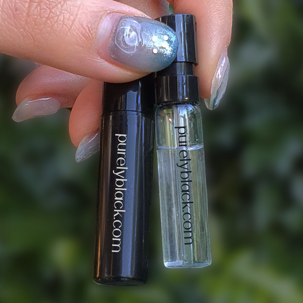 Travel sized glass spray bottle on dark wooden background Velvet Allure alternative Chanel Allure Sensuelle